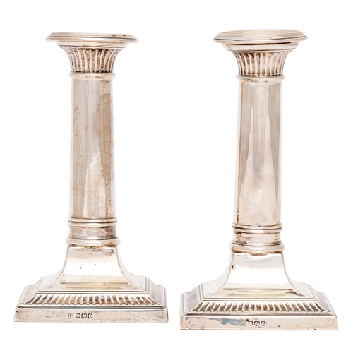 277 - A pair of George V dwarf columnar silver candlesticks, nozzles, 15.5cm h, by Thomas Bradbury & S... 