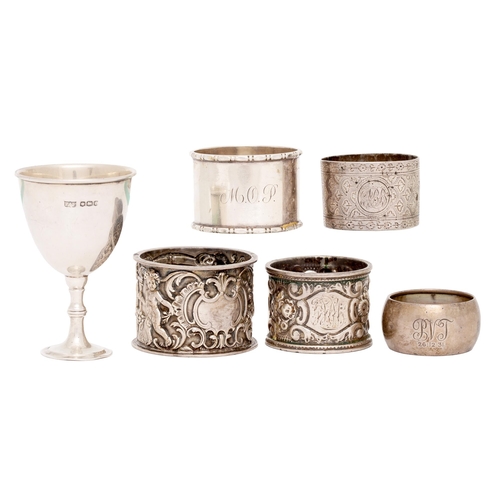 292 - Five silver napkin rings, Victorian and later and a silver egg cup, Sheffield 1923, 6oz 8dwt... 