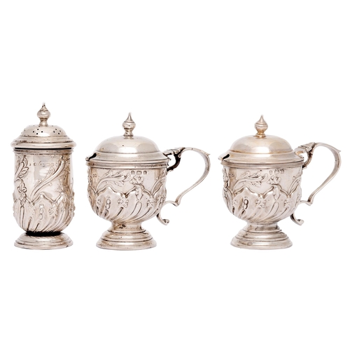 296 - A pair of Edwardian wrythen fluted silver mustard pots and a pepperette en suite, pepperette 86mm h,... 