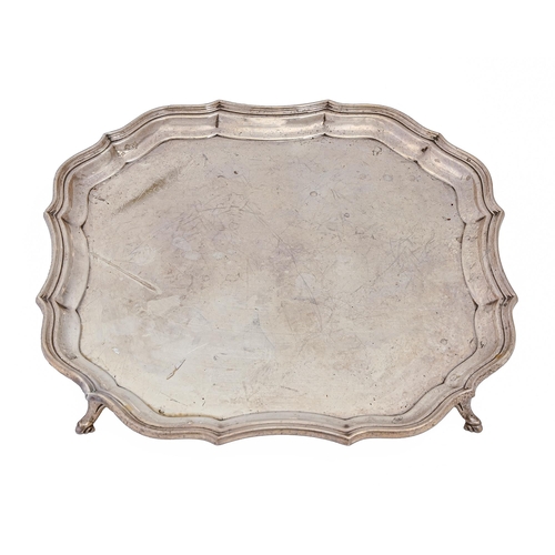 334 - A George V silver salver, the plain field with a moulded border and on four hoof feet, the underside... 