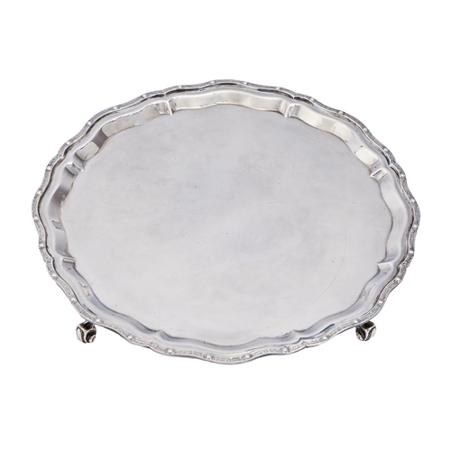 335 - An Elizabeth II silver salver, on four volute feet, 31cm diam, by Garrard & Co Ltd, Birmingham 1... 