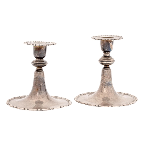 343 - A pair of Edwardian dwarf silver candlesticks, with C scroll rims, 12cm high, by The Goldsmiths &... 