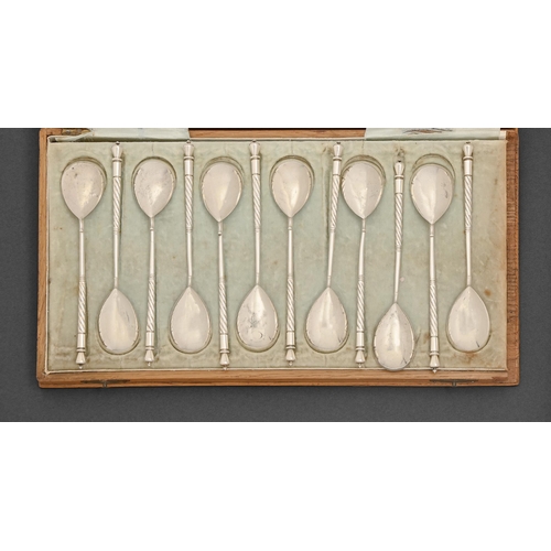 348 - A set of twelve Russian silver teaspoons, with spiral stem and fig-shaped gilt bowl, 14.5cm l, maker... 