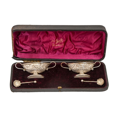 349 - A pair of Victorian silver salt cellars, on oval foot, 11.5cm over handles, spoons, by William Henry... 