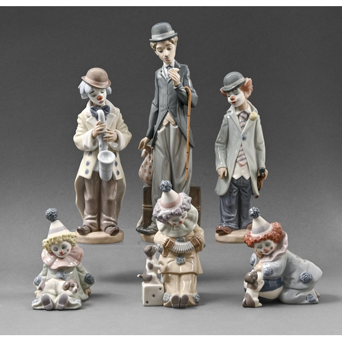 467 - A Lladro figure of Charlie Chaplin and five clowns, 28cm h and smaller, printed and impressed mark, ... 