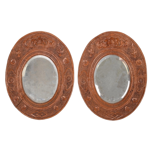 602 - A pair of Chinese carved sandalwood oval mirrors, 19th c, 34.5cm h (2)