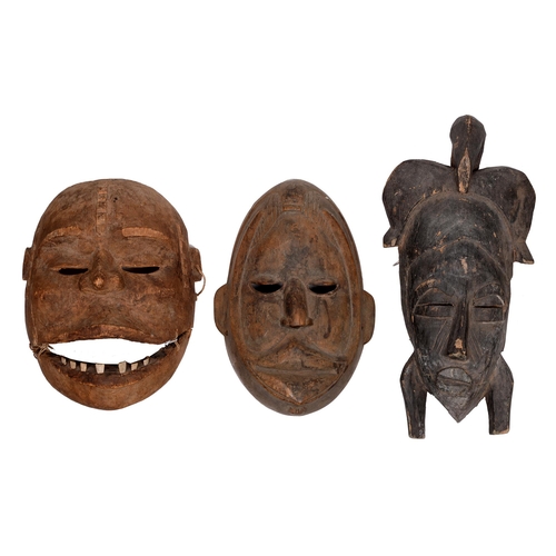 631 - Tribal art. West Africa - A Baule mask, a Senufo mask and another with bone teeth, 20th c, 41cm h an... 