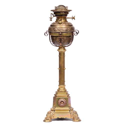 634 - A Victorian brass oil lamp, with duplex burner, by Hinks & Sons, the tripod base with lion mask ... 