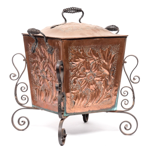 695 - An Arts and Crafts copper coal box, early 20th c, chased with leafy foliage, scrolling iron handles ... 