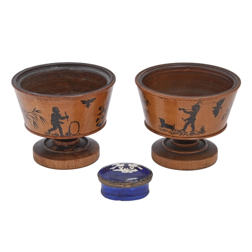 705 - A pair of turned wooden cups painted with silhouettes of children and animals, early 20th c and Sout... 