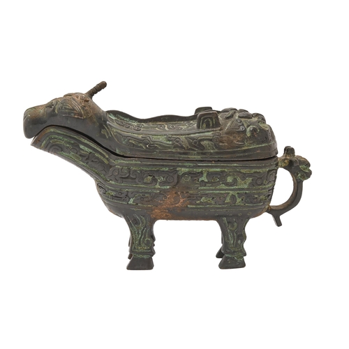 712 - A Chinese bronze ritual wine vessel, guang/gong, in the form of a dragon, the decoration divided int... 