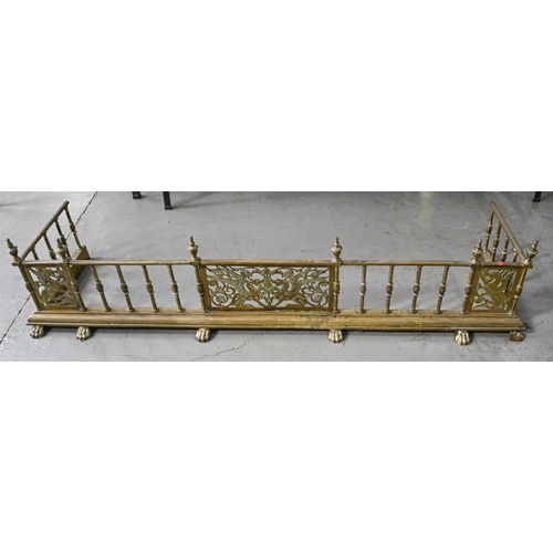 728 - An ornate Victorian brass galleried fender, with panels of mythical beasts, 32cm h; 39 x 146cm, loze... 