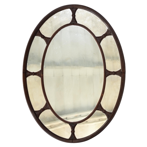 876 - An Edwardian mahogany oval mirror, with margin mirror surround, 108cm h