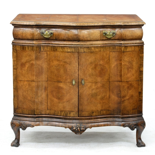 964 - A German serpentine walnut commode, c.1920, in matched veneers, 89cm h; 57 x 93cm