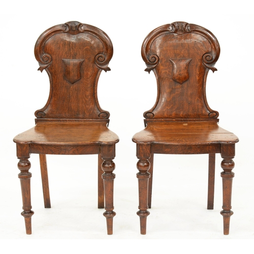 981 - A pair of Victorian oak shield-back hall chairs, seat height 41cm