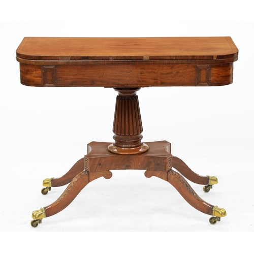 982 - A Victorian inlaid mahogany card table, on turned reeded pillar and legs, cast paw feet and castors,... 