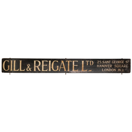 989 - A wooden shop sign, c.1920, 429 x 44.5cm, painted GILL & REIGATE LTD 25, SAINT GEORGE ST. HANOVE... 