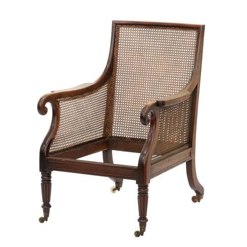 998 - A William IV mahogany bergère,  with caned back and sides, over-scrolled arms and reeded, tapering t... 