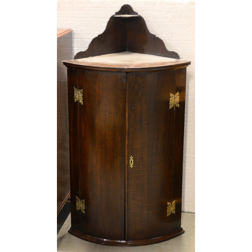 1041 - A Victorian oak bow fronted corner cabinet, with brass hinges, 116 x 61cm w