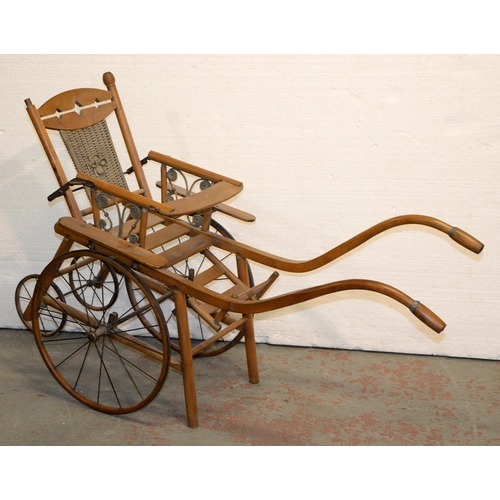 1050 - A beech and wicker perambulator, early 20th c, the two pairs of wheels with iron tyres, approx 134cm... 