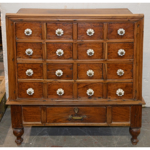 1056 - A South East Asian hardwood 'apothecary's cabinet', of sixteen drawers with white earthenware knobs,... 