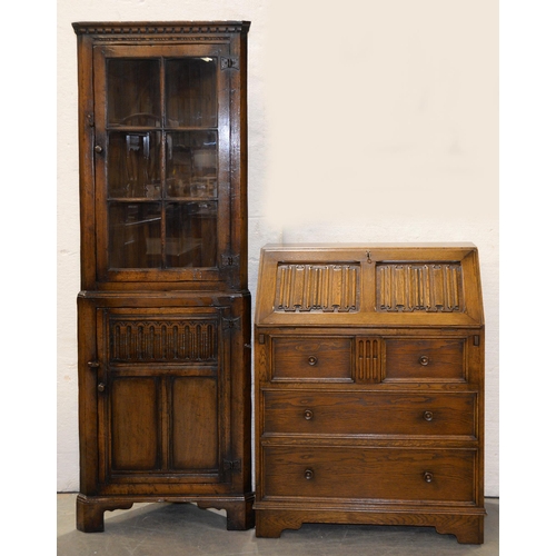 1068 - An oak corner cabinet and an oak bureau, each with linen fold panels, corner cabinet 179cm h... 