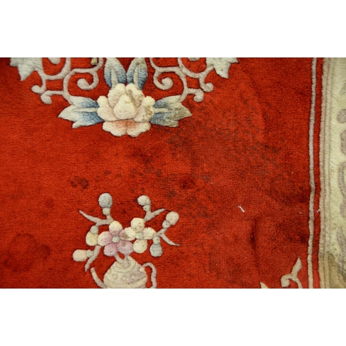 1071 - A Chinese red ground carpet, late 20th c, 270 x 360cm and two rugs (3)