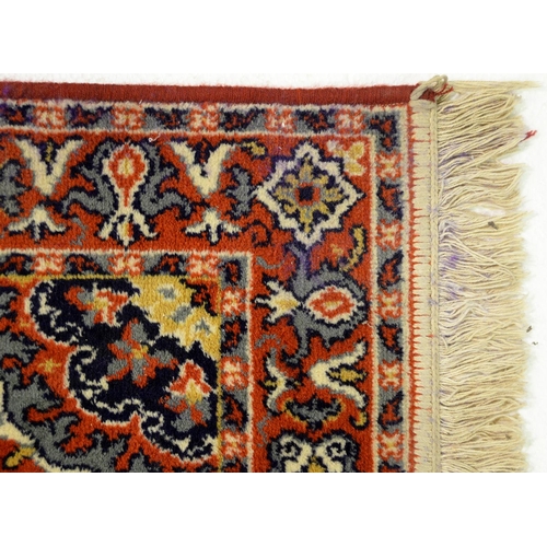 1071 - A Chinese red ground carpet, late 20th c, 270 x 360cm and two rugs (3)