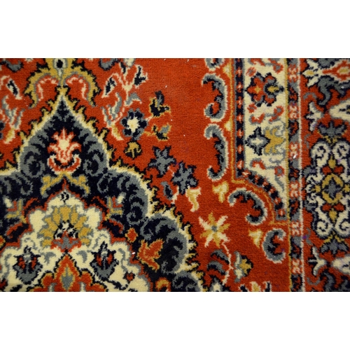 1071 - A Chinese red ground carpet, late 20th c, 270 x 360cm and two rugs (3)