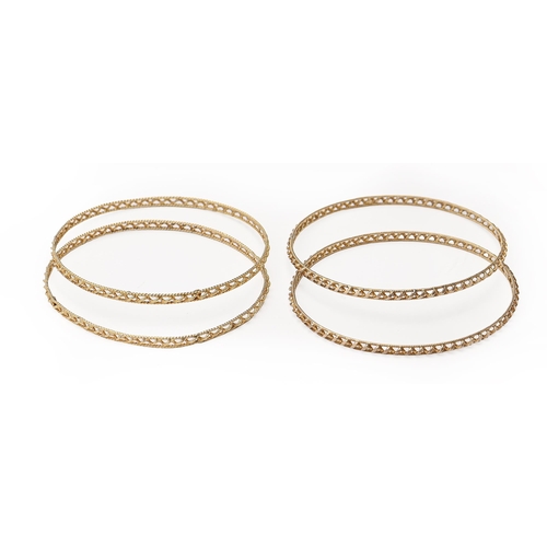 119 - A set of four gold openwork bangles, 67mm internal, marked 18K, 27g