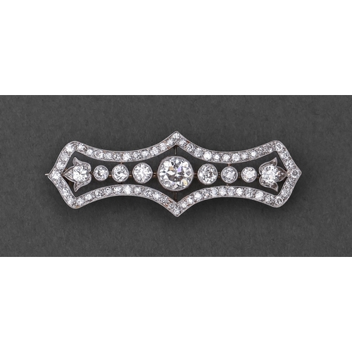 130 - A diamond brooch, c1920 of open incurved oblong shape with old cut diamonds, millegrain set in plati... 