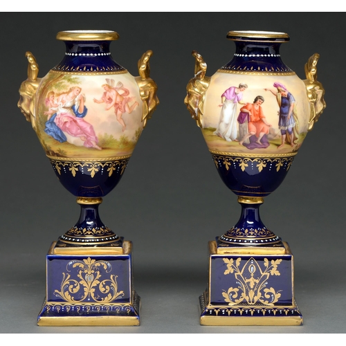 464 - A pair of Vienna style cobalt ground vases, early 20th c, of pear shape with gilt female mask handle... 