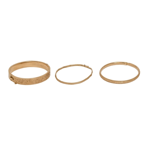 501 - A 9ct gold bangle,  59mm (internal), Birmingham 1955 and two other gold bangles, one import mar... 