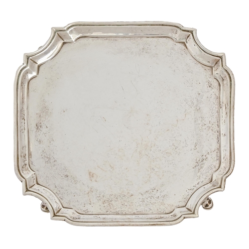 554 - A George II silver salver, shaped square, on hoof feet, the underside engraved with contemporary ini... 