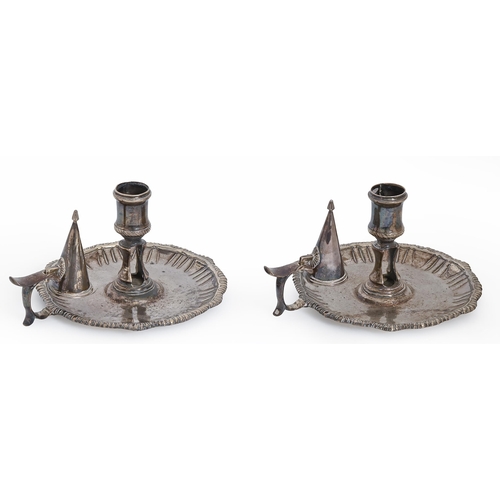 573 - A pair of George III silver chambersticks, with waisted sconce, fluted cavetto and gadrooned rim, 14... 