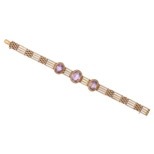 66 - An amethyst gate bracelet, early 20th c, in gold, 18.5cm l, marked 9c, 17.3g