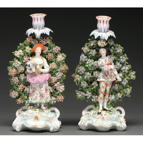 698 - Two Chelsea figural candlesticks, Gold Anchor period, c 1758-65, both painted with flowers and model... 