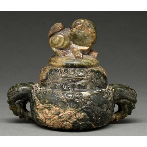 724 - A Chinese green hardstone vessel, late 19th/early 20th c, carved in relief with a ferocious dra... 