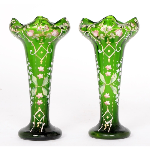 725 - A pair of green glass spill vases, c 1900, enamelled in polychrome with roses, lily of the valley, a... 