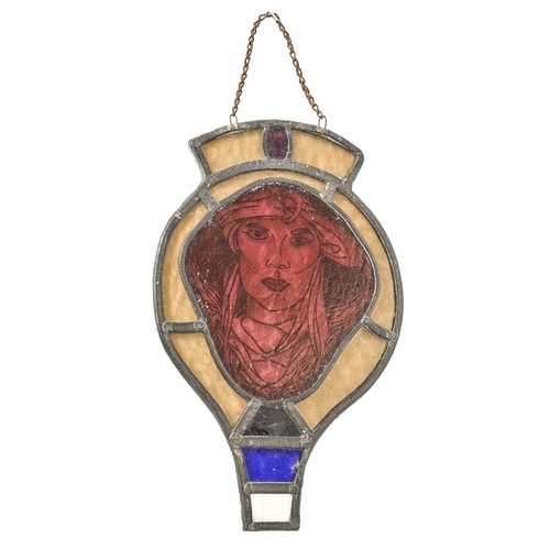 831 - An Arts and Crafts stained glass door or window light, first half 20th c, painted with the face of a... 