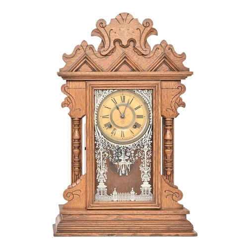 832 - An Ansonia carved oak wall clock, early 20th c, pendulum and key, 60cm h