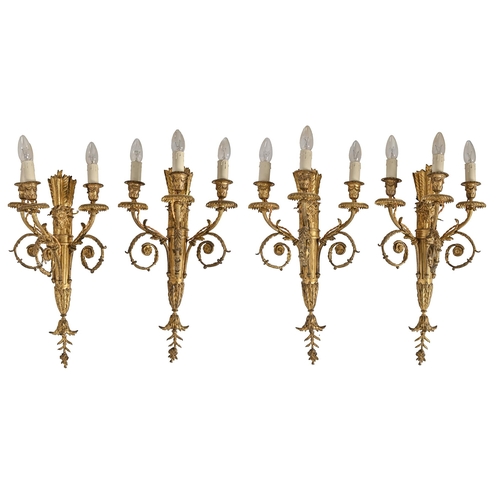 842 - A set of four antique style gilt metal three-branch electric wall lights, early 20th c, 59 x 32cm ex... 