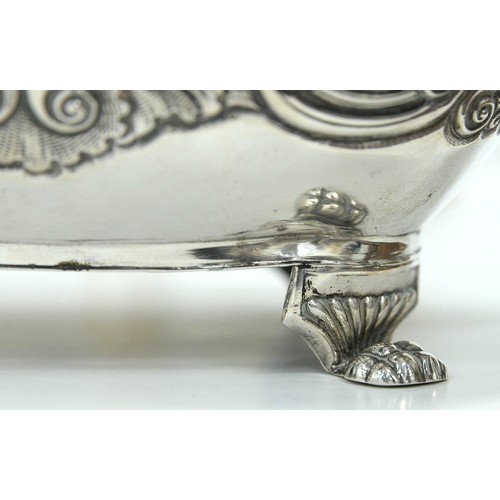 338 - An Irish George IV silver teapot, chased with flowers and foliage, on four paw feet, ivory insulator... 