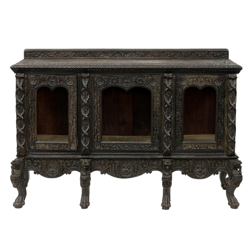 1202 - An Indian carved Bombay blackwood cabinet, Mumbai region, late 19th c, the arched top doors flanked ... 