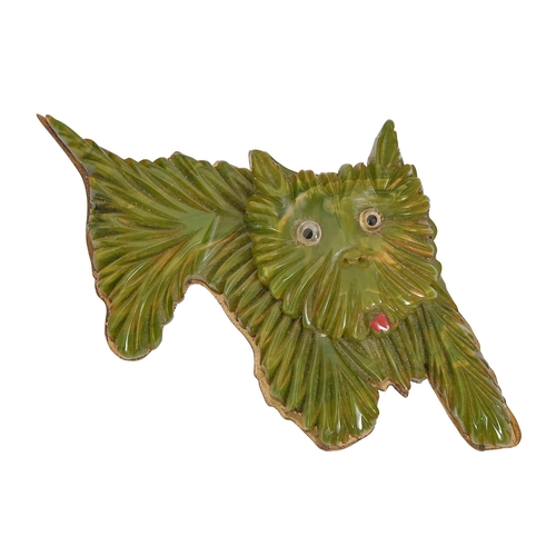 106 - An art deco phenolic resin ('Bakelite') dog brooch in the form of a terrier, c1930, backed on brass,... 