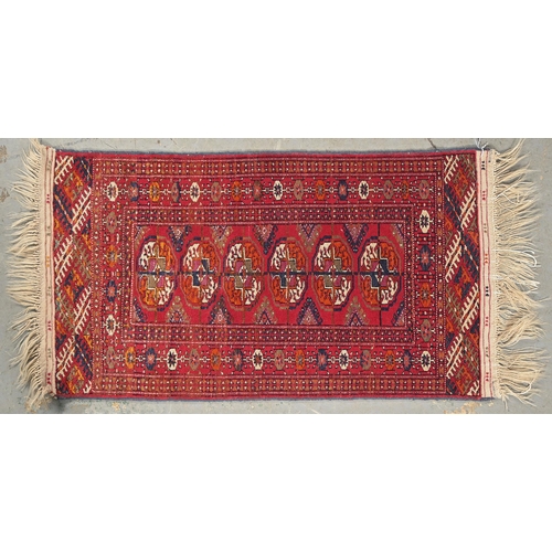 1067 - A Middle Eastern rug, 102 x 57cm