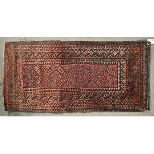 1072 - An antique baluch rug, 112 x 57cm