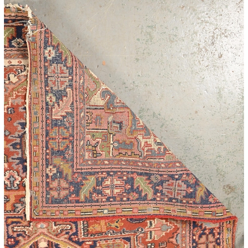 1091 - A small Heriz carpet, 242 x 173cm and a Brussels tapestry, 145 x 126cm