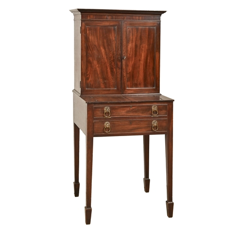 1107 - A George III mahogany lady's writing cabinet, the upper part enclosed by panelled doors, the table w... 