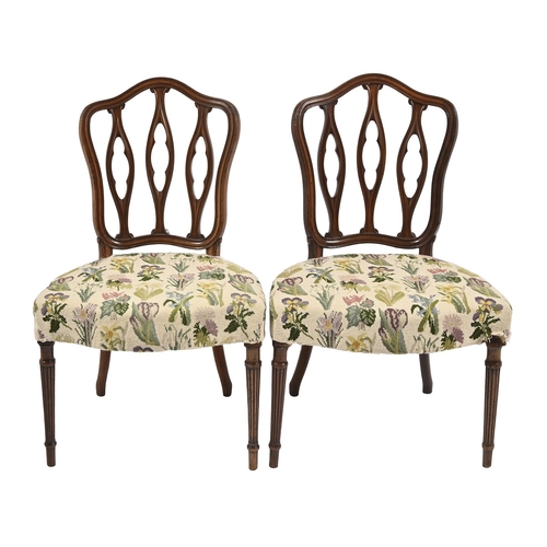 1108 - A pair of George III mahogany dining chairs, based on a design by George Hepplewhite, the French sty... 